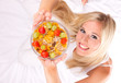 Photo: Attractive girl holding healthy bowl of cereals. Attractive girl holding healthy bowl of cereals.