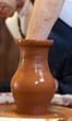 hands of a potter, creating an earthen jar on the circle