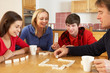 Family Playing Dominoes In Kitchen