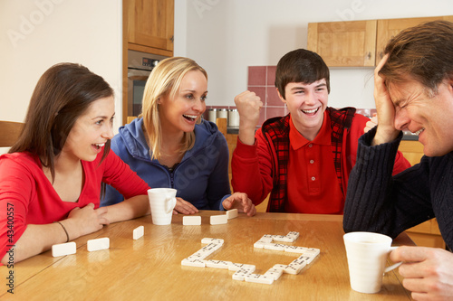 Photo: Family Playing Dominoes In Kitchen Family Playing Dominoes In Kitchen