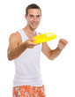 Photo: Happy young man playing with flying disc Happy young man playing with flying disc