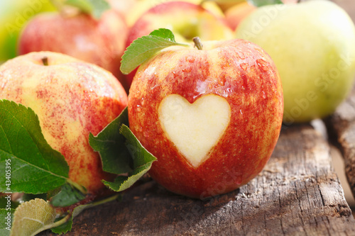 Photo: Fresh red apple with heart cutout Fresh red apple with heart cutout