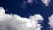Time lapse clouds over blue sky