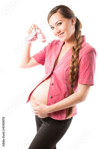 Photo: happy pregnant woman with pink booties happy pregnant woman with pink booties