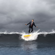 Foto: Young business person surfing on the waves Young business person surfing on the waves