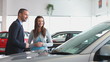 Businessman showing a car to a woman