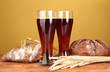 two glasses of kvass with bread on brown background close-up