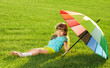 Photo: Smiling Little girl Kid in park with colorfull umbrella Smiling Little girl Kid in park with colorfull umbrella