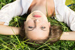 Photo: Young female relaxing in the grass Young female relaxing in the grass
