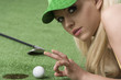 Foto: girl's playing with golf ball looks in to the lens girl's playing with golf ball looks in to the lens