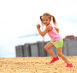 Little girl running in sand