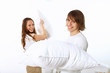 Young couple fighting with pillows