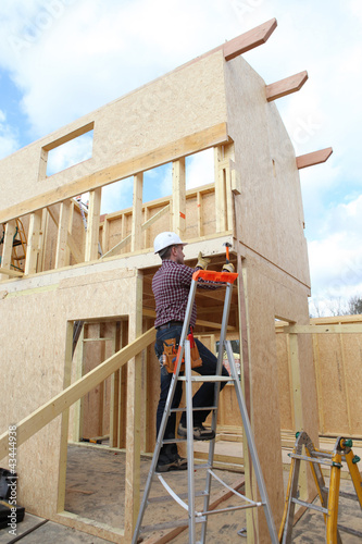 Photo: Construction worker building a house Construction worker building a house