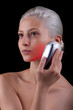 Photo: Young woman getting photo-therapy treatment with red light Young woman getting photo-therapy treatment with red light