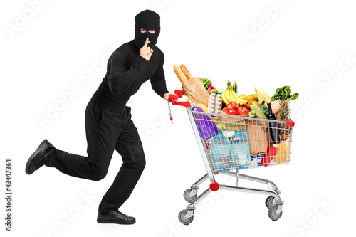 Photo: Robber stealing a pushcart with products Robber stealing a pushcart with products
