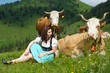 Junge Frau im Dirndl auf da Alm