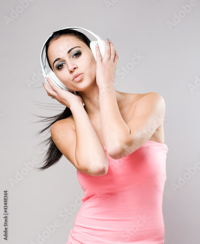 Photo: Gorgeous young brunette enjoying music. Gorgeous young brunette enjoying music.
