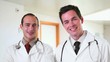 Two smiling doctors walking