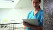 Serious nurse writing on a clipboard