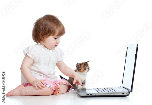 Photo: kid girl playing with kitten and laptop kid girl playing with kitten and laptop