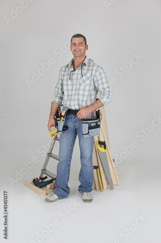 Photo: Carpenter posing by his equipment Carpenter posing by his equipment