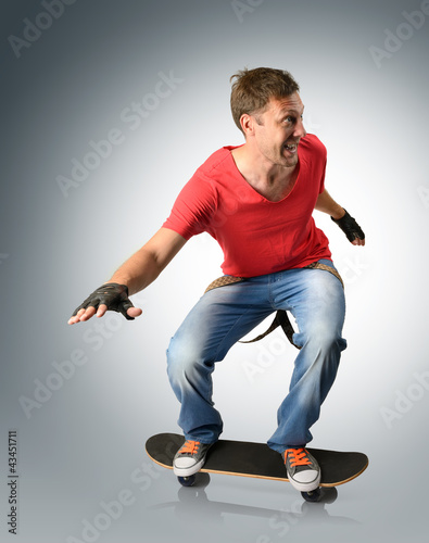 Photo: Funny man with suspender on a skateboard Funny man with suspender on a skateboard