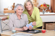 Two mature women playing cards.
