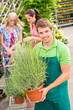 Photo: Garden centre worker hold potted plant Garden centre worker hold potted plant