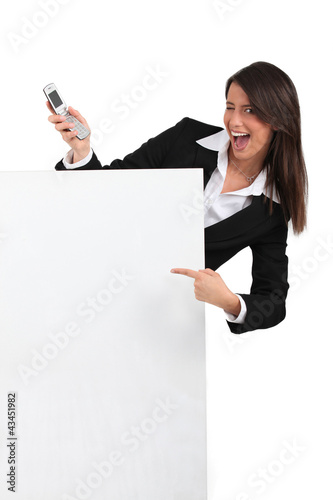 businesswoman winking and holding a cell phone