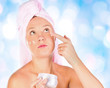 Beautiful woman tender jar of moisturizer cream.