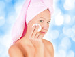 A close up of a beautiful young woman removing her make up.