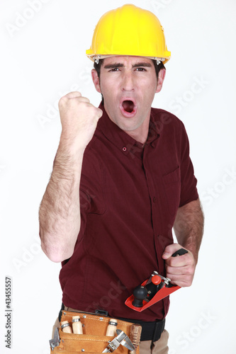 Photo: A victorious construction worker. A victorious construction worker.