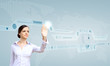 Foto: Businesswoman and touch screen technology Businesswoman and touch screen technology