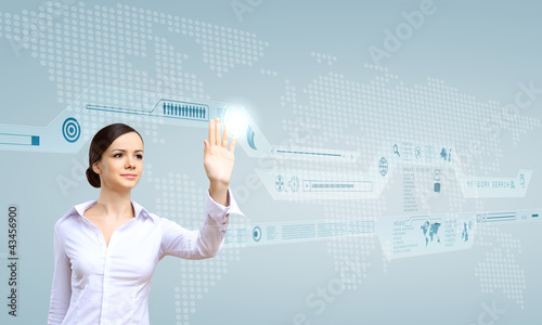 Photo: Businesswoman and touch screen technology Businesswoman and touch screen technology