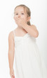 Little girl covering her mouth