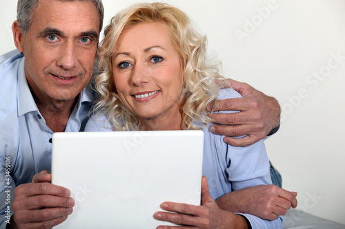 Photo: Middle-aged couple with computer Middle-aged couple with computer