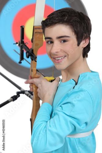 Photo: boy practicing archery boy practicing archery