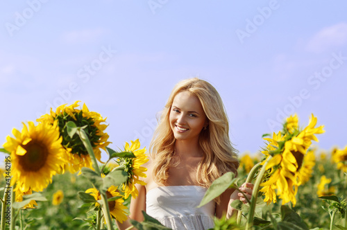 Photo: young beautiful woman on field in summer young beautiful woman on field in summer