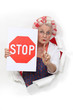 Granny holding a stop sign and with her hair in rollers