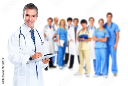 Foto : Smiling medical doctor writing a prescription. Smiling medical doctor writing a prescription.