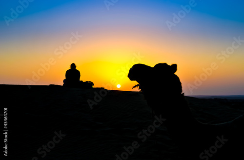 Photo: A woman and a camel at sunset on the Thar Desert, India A woman and a camel at sunset on the Thar Desert, India