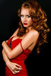 Photo: Beautiful, daring red-haired girl in a red dress Beautiful, daring red-haired girl in a red dress
