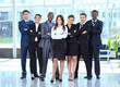 Happy young business woman with her team in