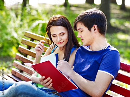 Photo: Couple student with notebook outdoor. Couple student with notebook outdoor.