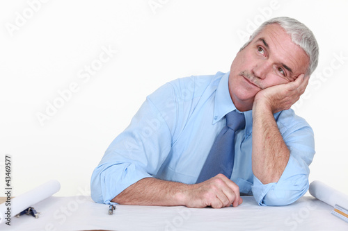 Photo: Bored architect staring off into space Bored architect staring off into space