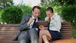 Video: Successful business couple with tablet computer in the park, Successful business couple with tablet computer in the park,