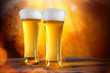 Photo: Beer in a glasses with gold background Beer in a glasses with gold background