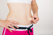 Foto: Young adult checking her belly fat Young adult checking her belly fat