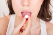 Young woman taking pills