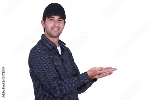 Photo: Man in a cap holding blank copyspace Man in a cap holding blank copyspace